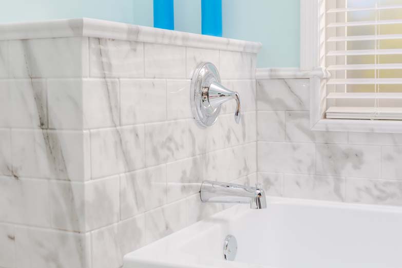 light blue bathroom bathtub faucet side view