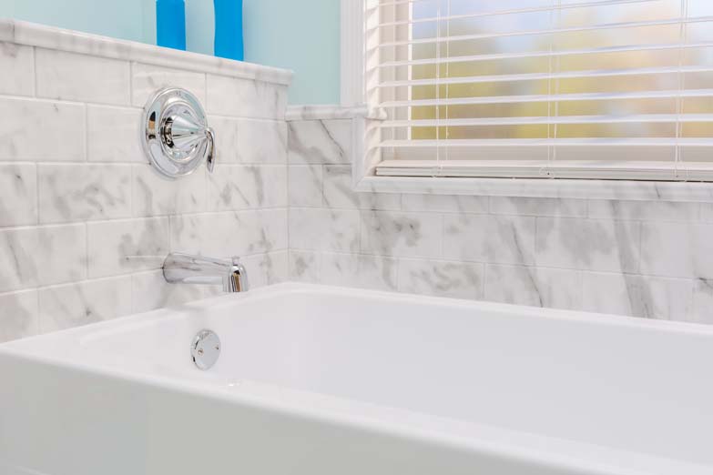 light blue bathroom bathtub with faucet and window