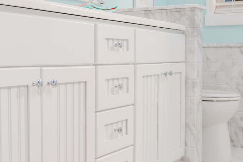 sink cabinet with toilet on the right in light blue bathroom