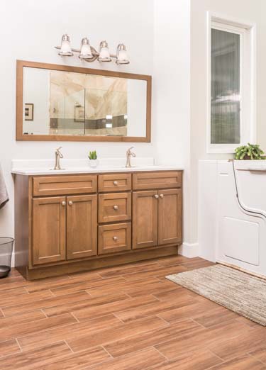 brown sink cabinet with mirror and wall lights