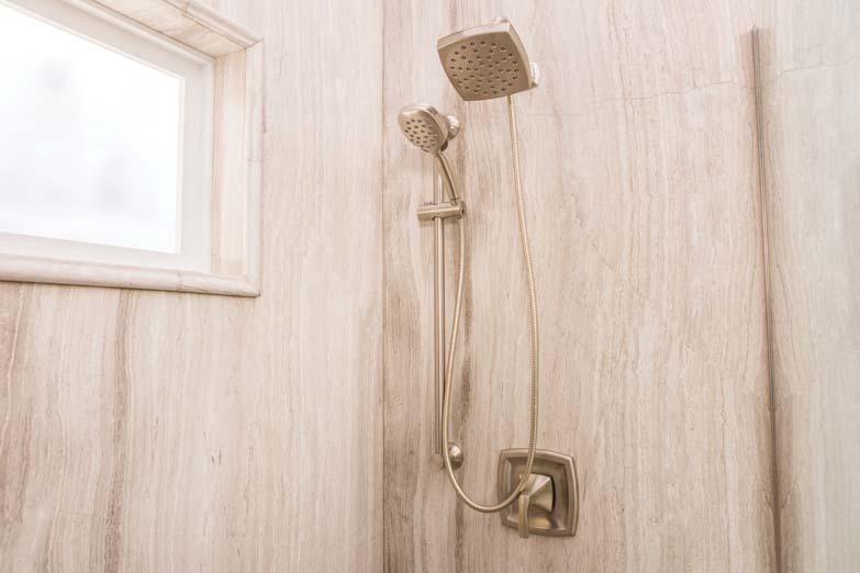 two tan shower heads with window