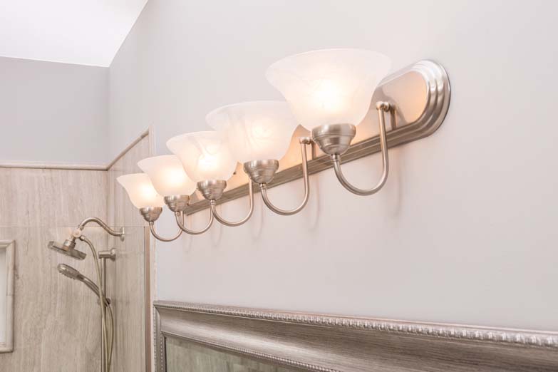 set of 5 wall lights with shower heads in the corner of the room