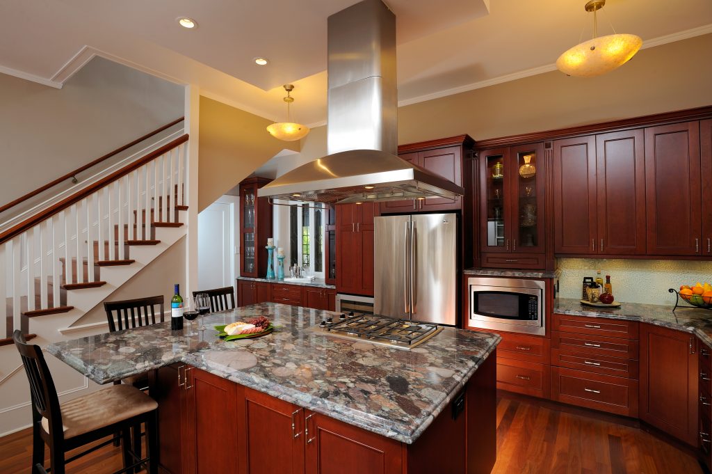 a kitchen with a range and marble counters
