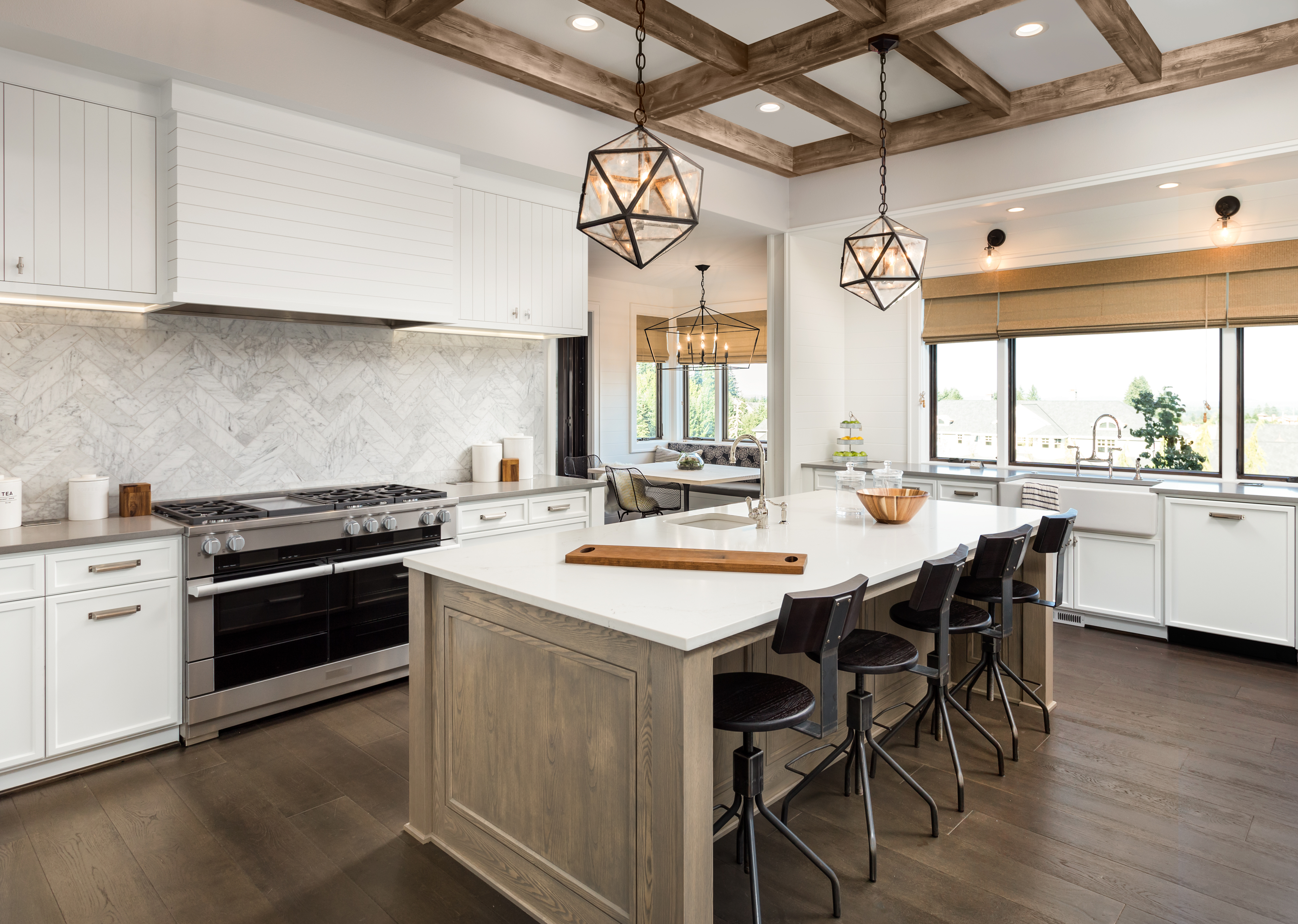 Well lit kitchen with pendant lighting and tan accents