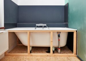 A bathtub under a wood frame