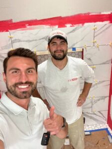 Two team members of Re-Bath & Kitchens take selfie on job site in Arizona 